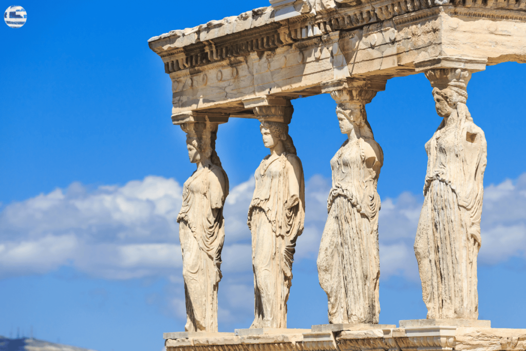 ancient status in greece with blue sky and clouds on the background